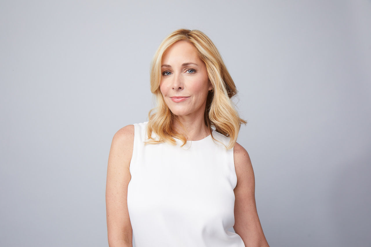 blond woman looking out on a grey background
